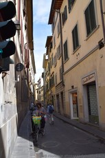Italian Woman checking her phone on a bicycle in Florence next to Sorelle Bacci.jpg