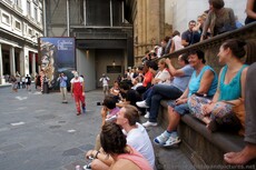 Group of Locals and Tourists sitting at Loggia dei Lanzi watching Clown.jpg